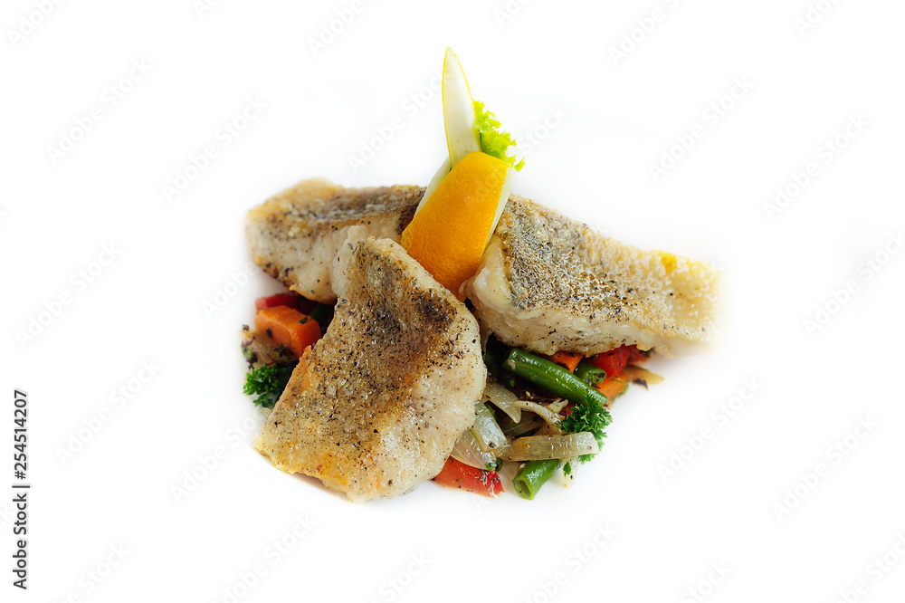 Grilled fish with vegetables isolated on the white Grilled fish with vegetables isolated on the white