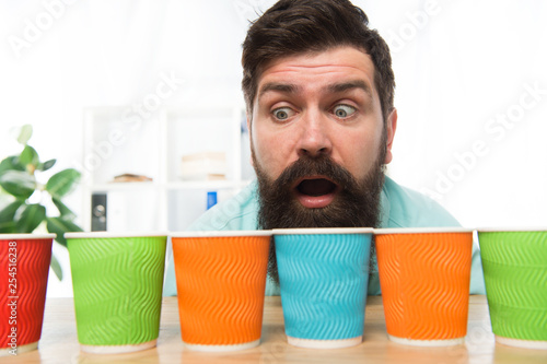 Curious man looks on colorful coffee cups. Color your day. Different types of coffee drinks in cafe menu. large assortment. assortment of coffee. energy drink assortment. bearded man want to drink photo