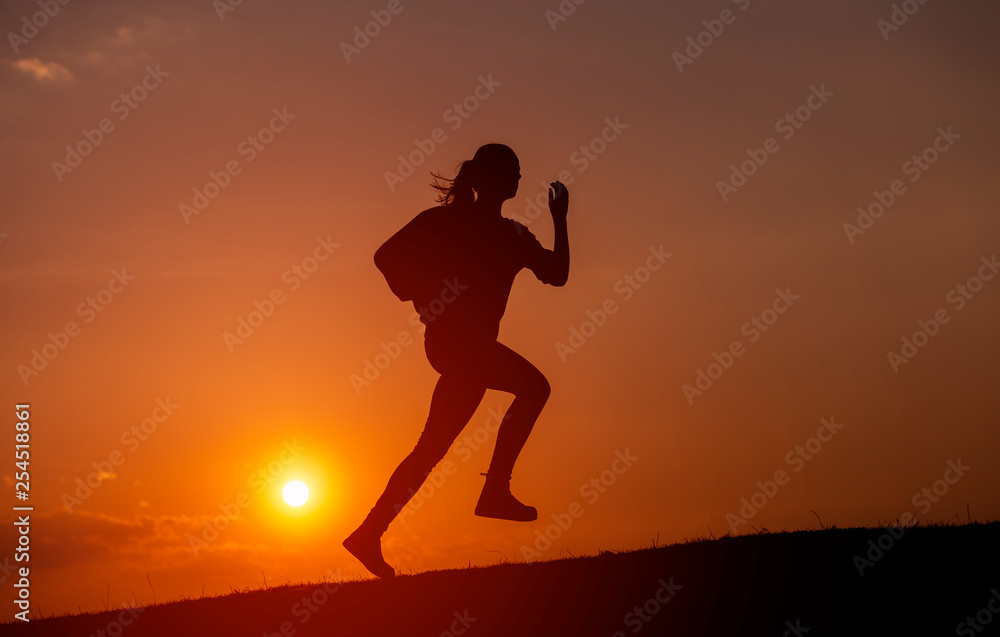 Female Runner Silhouette, Running into sunset, colorful sunset sky
