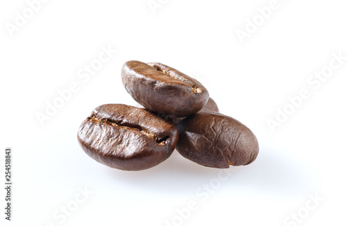 Roasted coffee beans close-up isolated on white background.