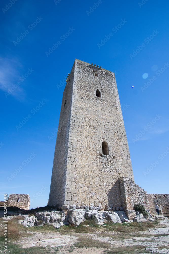 view of the medieval hillside town of Alarcon, Spain, which is located on the Jucar River. It is a popular tourist destination with the castle and guard tower pictured view of the medieval hillside town of Alarcon, Spain, which is located on the Jucar River. It is a popular tourist destination with the castle and guard tower pictured
