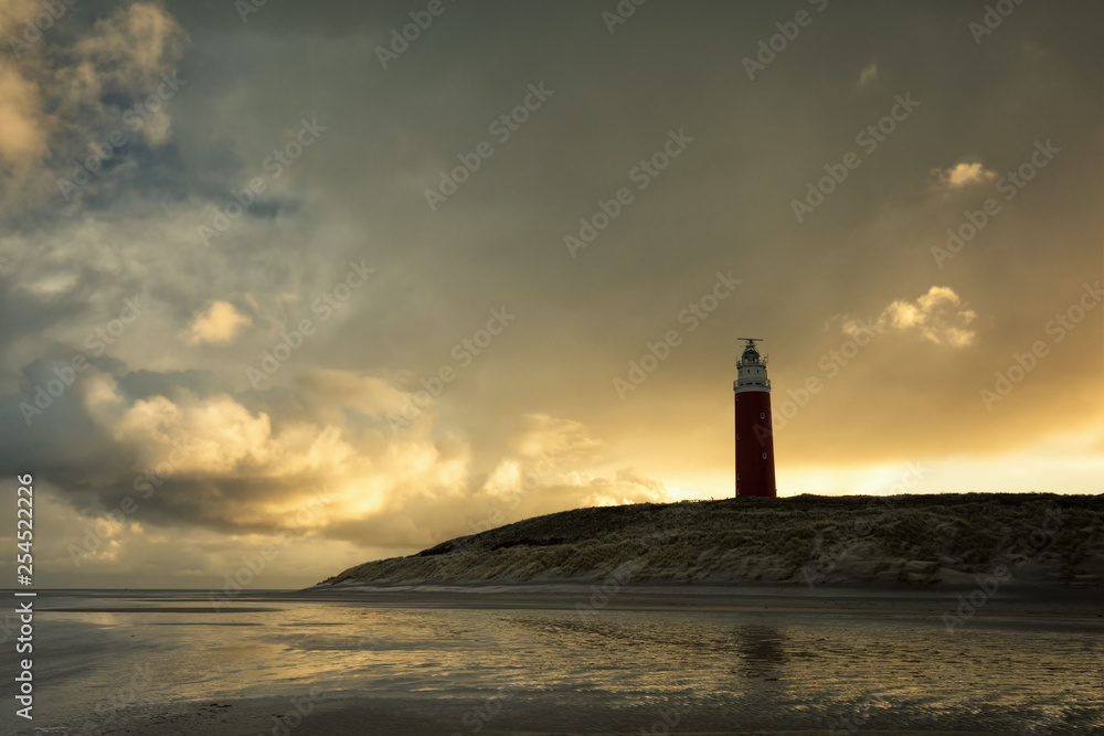 dramatic sunrise over lighthouse during storm