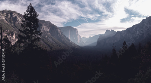 Morning sun rays pierce through the crisp autumn air, illuminating El Capitan in Yosemite Valley © Tabor Chichakly