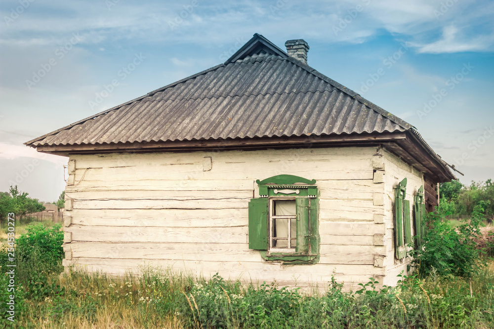 Old green shutters and a window on the facade of an old wooden farmhouse. Old green shutters and a window on the facade of an old wooden farmhouse.