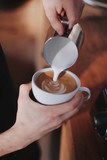 man pouring cup of coffee