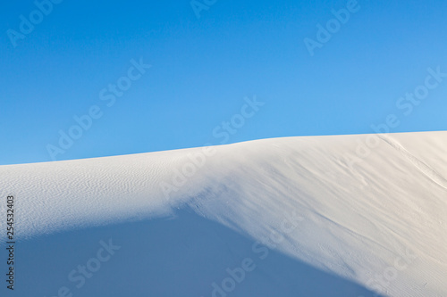 White gypsum sand in White Sands National Monument, with a clear blue sky overhead