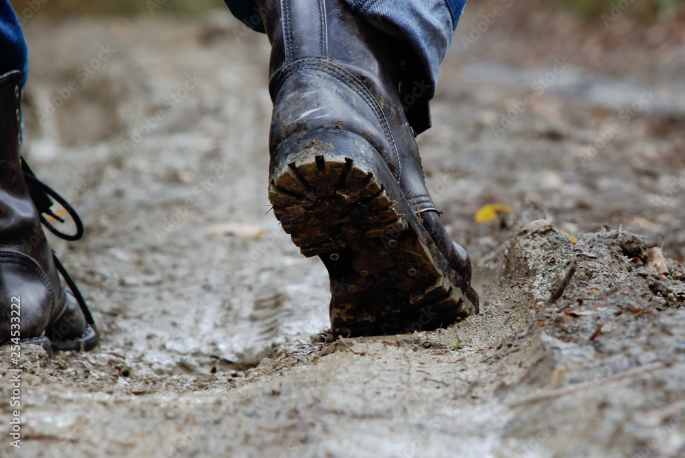 A man in ankle boots walking through the mud, forest road, close-up Stock  Photo | Adobe Stock