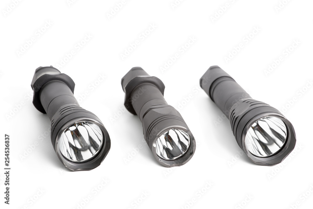 Many camping or tactical handheld pocket black flashlights isolated studio shot Many camping or tactical handheld pocket black flashlights isolated studio shot