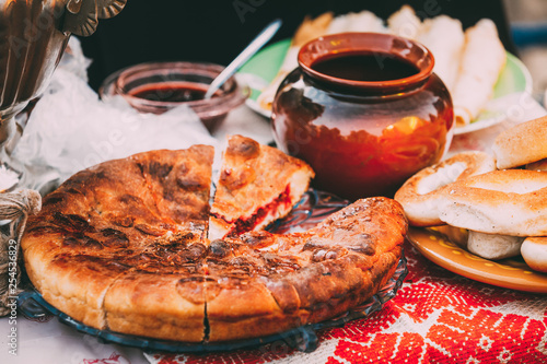 Dishes of the traditional Belarusian cuisine - pie and honey.