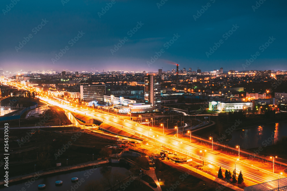 Minsk, Belarus. Aerial View Cityscape In Bright Blue Hour Evening And Yellow Illumination Spring Twilight.  Night View Of Independence Avenue