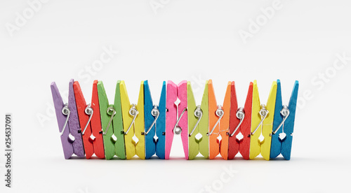 Colorful wooden clothespins on white background