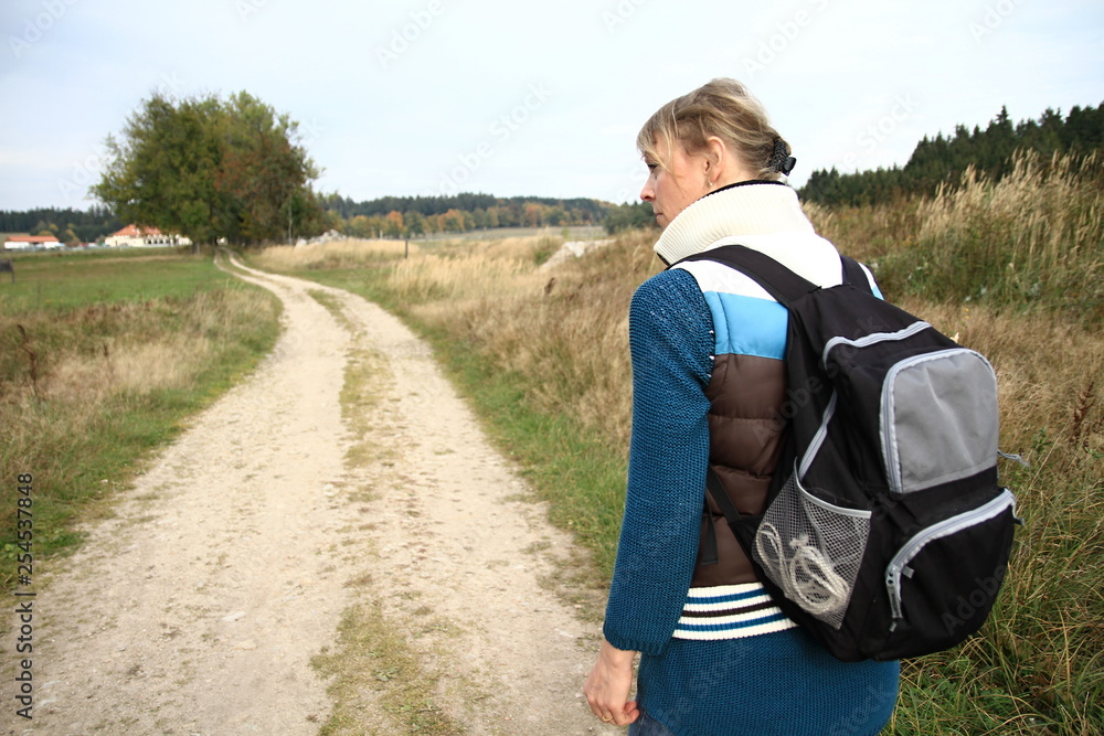 woman with rucksack walking in the country woman with rucksack walking in the country