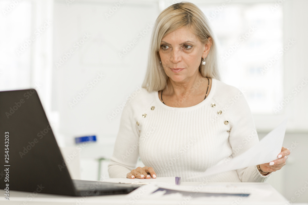 Cheerful senior businesswoman at the office Cheerful senior businesswoman at the office