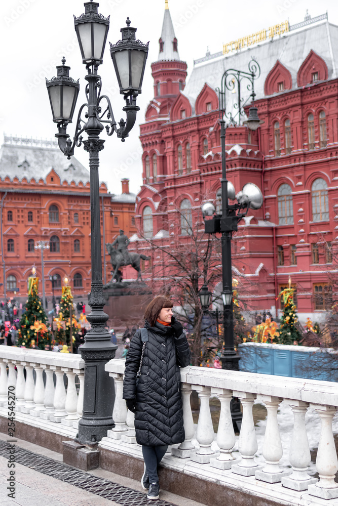 Young russian woman on a Red Square close to Kremlin. Moscow city.