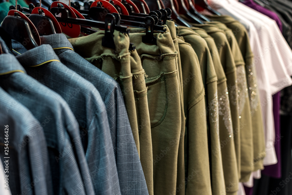 Obraz premium colorful clothes hanging on store racks