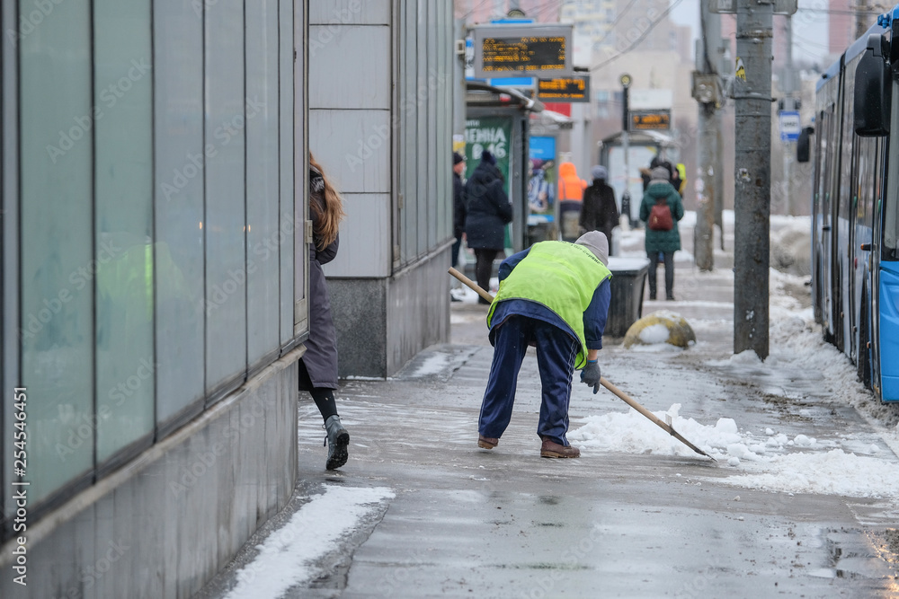 custom made wallpaper toronto digitalMoscow, Russia - March, 4, 2019: image of snow clearing by people from public utilities in Moscow near the bus stop