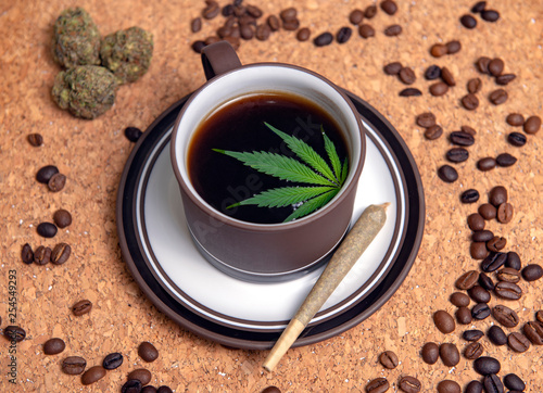 Cannabis coffee cup with marijuana leaf, joint, nugs and coffee beans photo