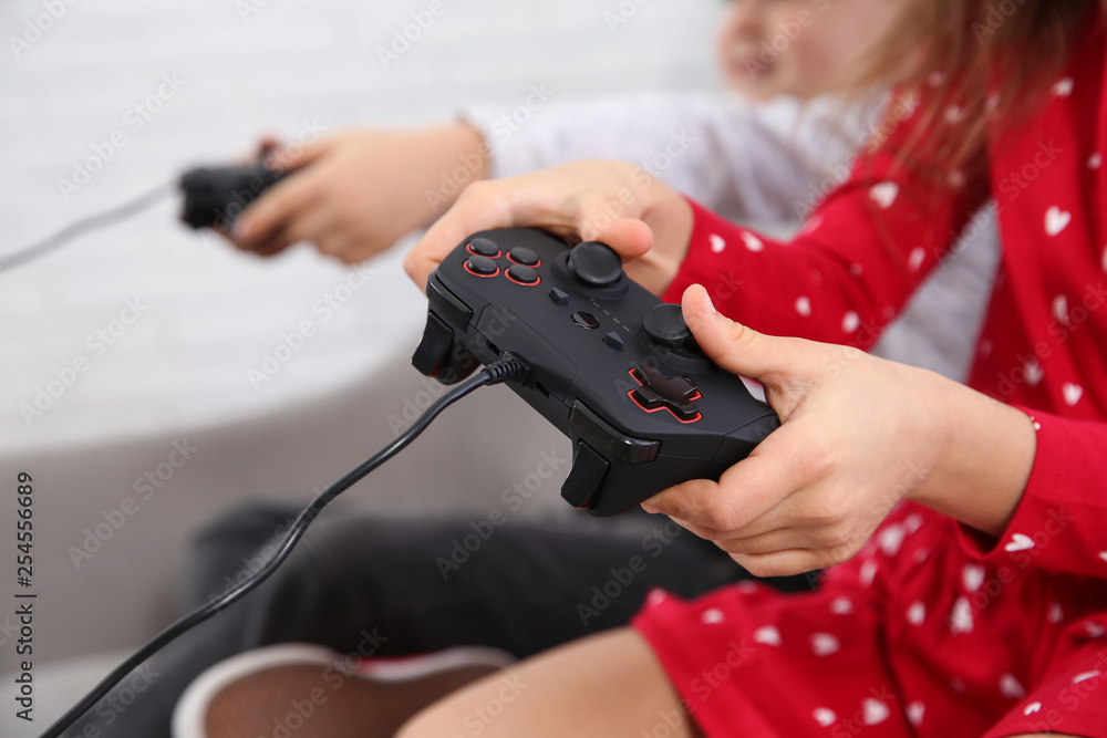 Children playing video game at home, closeup Children playing video game at home, closeup