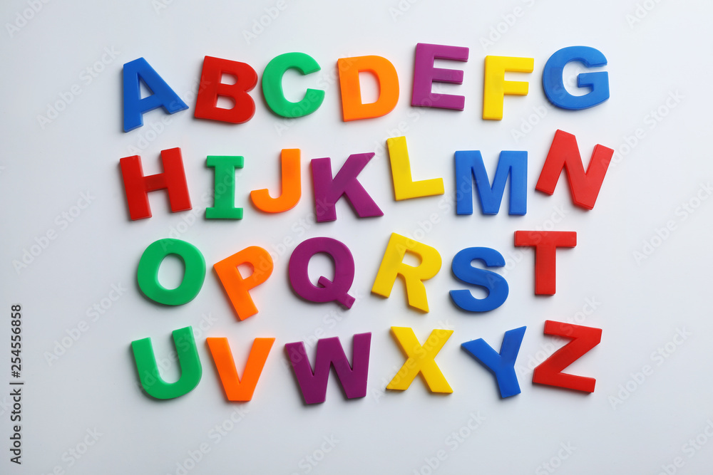 Plastic magnetic letters isolated on white, top view. Alphabetical order Plastic magnetic letters isolated on white, top view. Alphabetical order