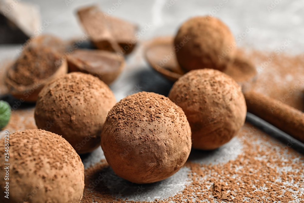Delicious raw chocolate truffles on grey background Delicious raw chocolate truffles on grey background