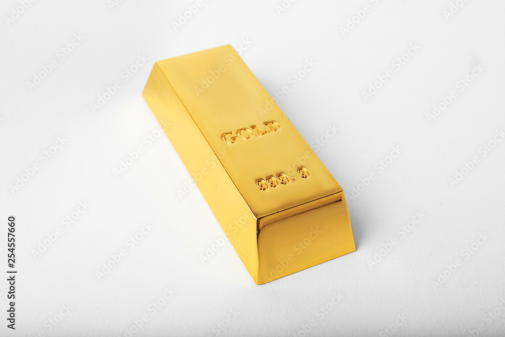 Precious shiny gold bar on white background Precious shiny gold bar on white background