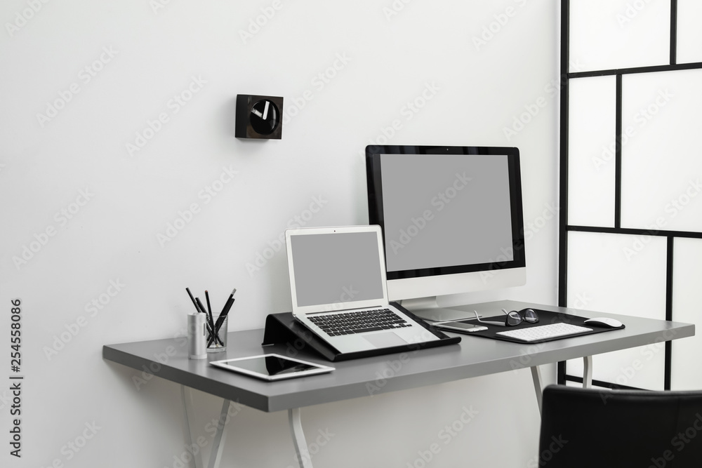 Modern workplace interior with computers on table. Space for text Modern workplace interior with computers on table. Space for text