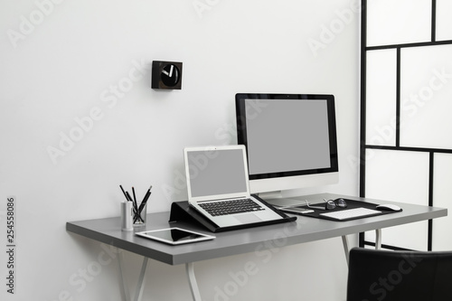 Wallpaper Mural Modern workplace interior with computers on table. Space for text Torontodigital.ca