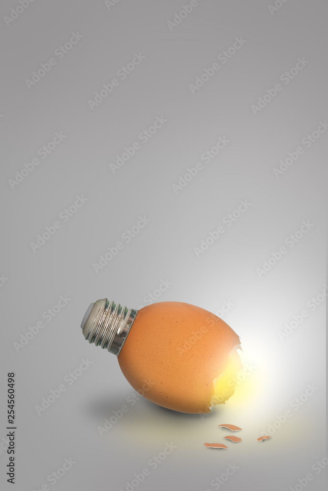 Contemporary art of lightbulb egg on grey background with copy space Contemporary art of lightbulb egg on grey background with copy space