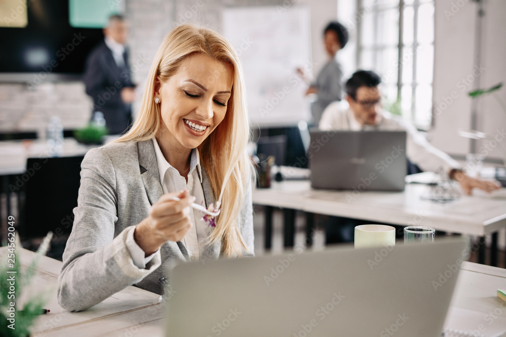 Happy woman enjoying on lunch break in the office.