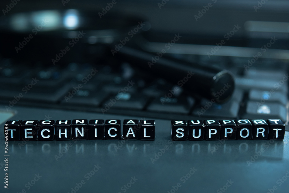 Technical Support text wooden blocks in laptop background. Business and technology concept Technical Support text wooden blocks in laptop background. Business and technology concept