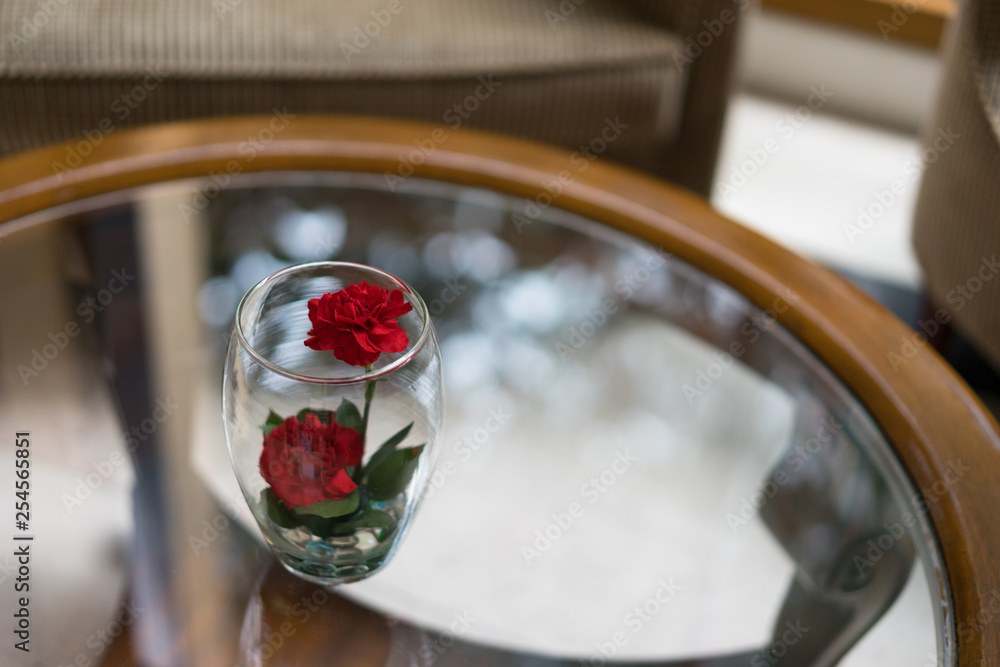red rose flower in glass