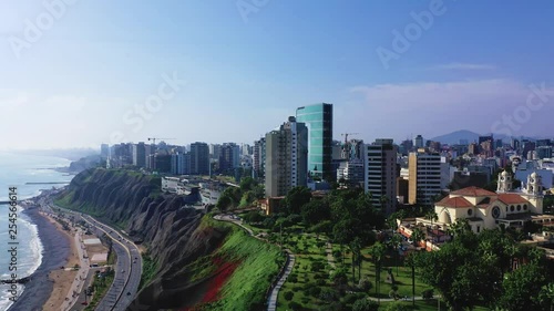 Aerial view of Miraflores shoreline including Domodossola park and Larcomar shopping mall. Clear and bright day, travel and destinations concept. Drone aerial shot of Lima's cityscape. photo