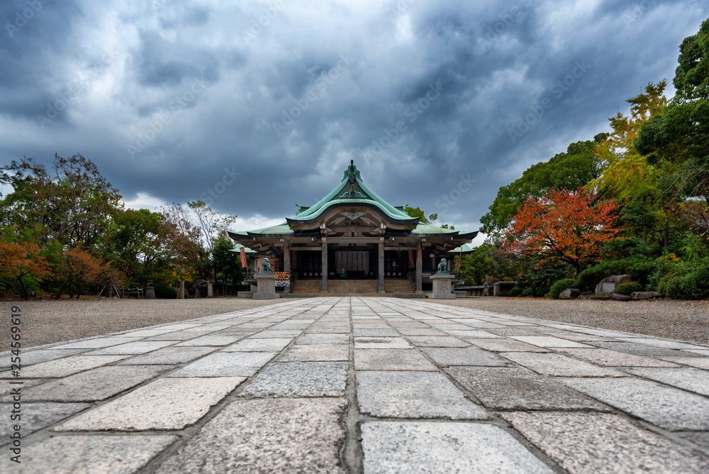 Scene at the Osaka Castle grounds on a cloudy day in Osaka, Japan with modern buildings in the background Scene at the Osaka Castle grounds on a cloudy day in Osaka, Japan with modern buildings in the background