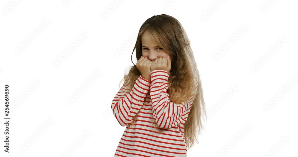 Pretty shy cute girl with long blond hair and in the striped blouse closing her face with hands on the white wall background. Pretty shy cute girl with long blond hair and in the striped blouse closing her face with hands on the white wall background.