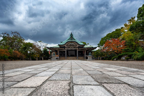 Scene at the Osaka Castle grounds on a cloudy day in Osaka, Japan with modern buildings in the background