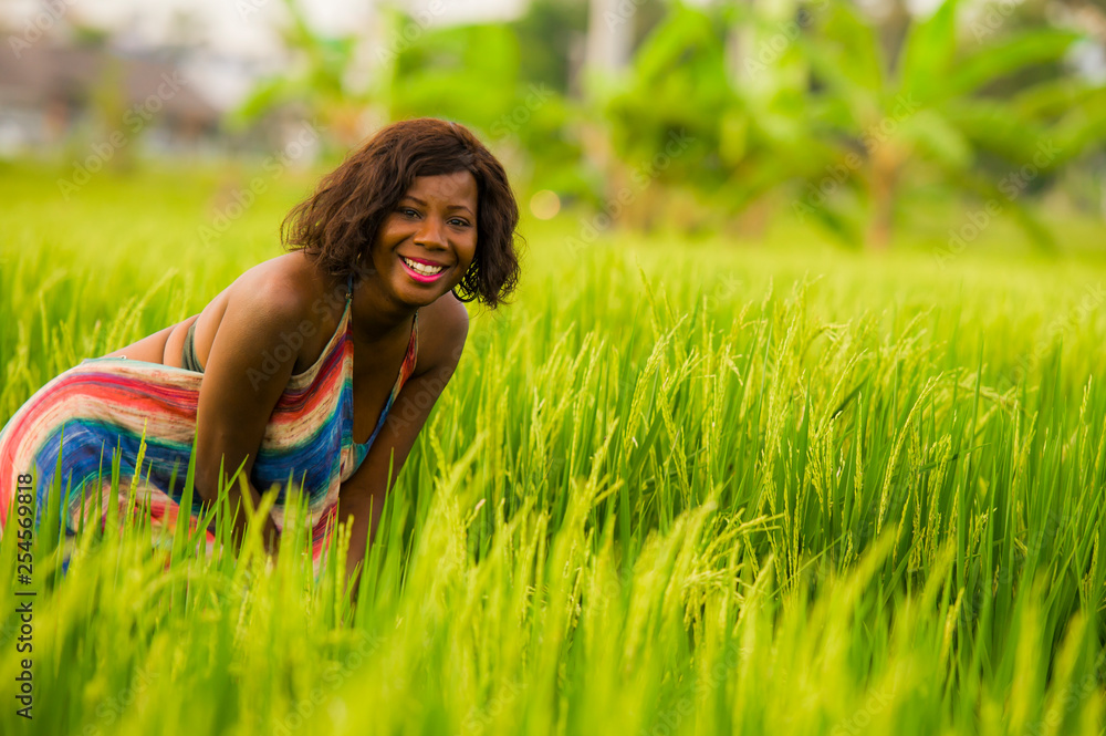 lifestyle portrait of young attractive and happy black African American woman posing cheerful having fun outdoors at beautiful rice field background enjoying holidays trip lifestyle portrait of young attractive and happy black African American woman posing cheerful having fun outdoors at beautiful rice field background enjoying holidays trip