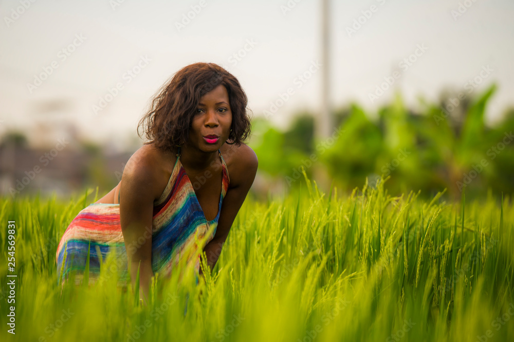 lifestyle portrait of young attractive and happy black African American woman posing cheerful having fun outdoors at beautiful rice field background enjoying holidays trip lifestyle portrait of young attractive and happy black African American woman posing cheerful having fun outdoors at beautiful rice field background enjoying holidays trip