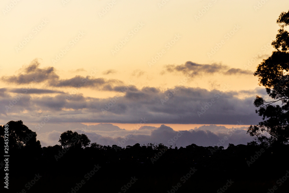 Rolling cloudscape over silhouette horizon at dusk. Rolling cloudscape over silhouette horizon at dusk.