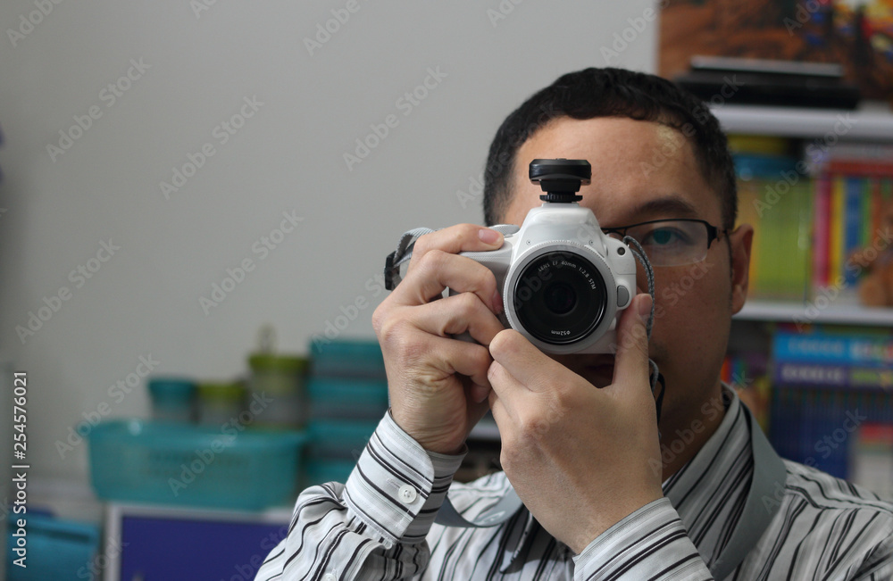 Man takes picture with mirror camera in room Man takes picture with mirror camera in room
