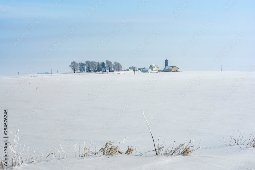 Farm field and farm house in winter time Farm field and farm house in winter time