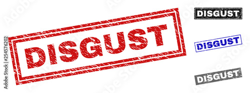 Grunge DISGUST rectangle stamp seals isolated on a white background. Rectangular seals with grunge texture in red, blue, black and grey colors.