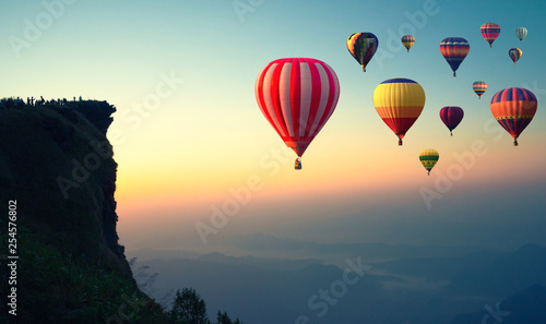 Colorful hot air balloons flying over the mountain.
