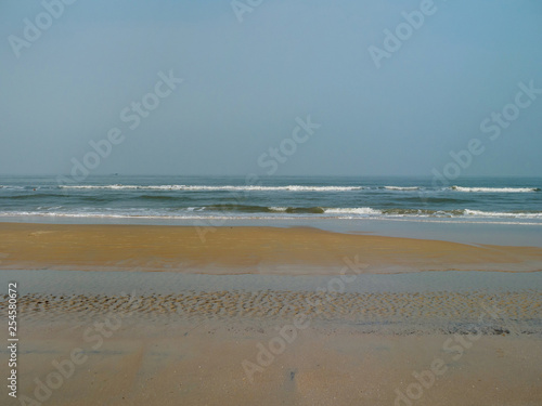 Coast of the Indian Ocean. Golden sand and calm blue sea