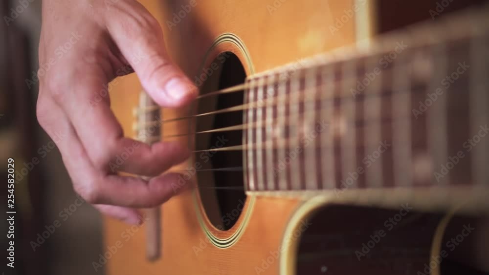 Close Up Of Finger Picking And Plucking Patterns On Acoustic Guitar