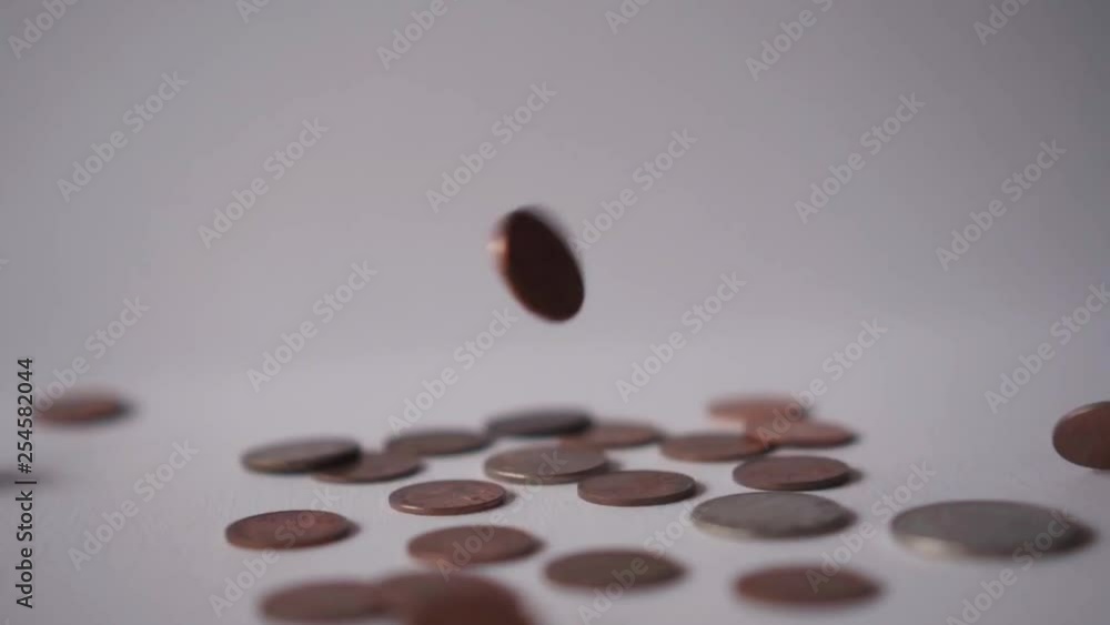 Falling Or Dropping Copper And Silver Coins On A White Surface With Clean White Background Falling Or Dropping Copper And Silver Coins On A White Surface With Clean White Background