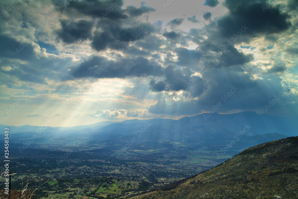Sun rays through the clouds mountains and valley , in Arcadia Greece. Sun rays through the clouds mountains and valley , in Arcadia Greece.