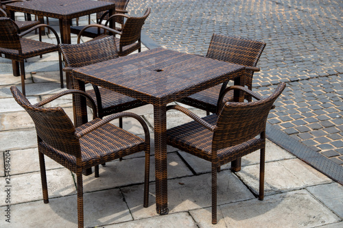 Empty rattan tables and chairs
