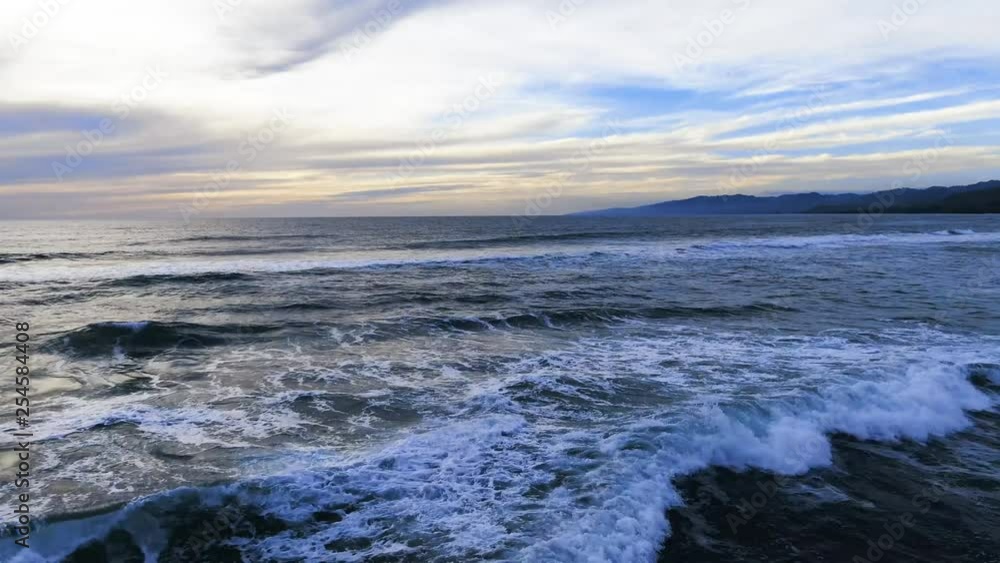 Sunset leaking through cloud cover at beach. Vibrant and beautiful Sunset leaking through cloud cover at beach. Vibrant and beautiful