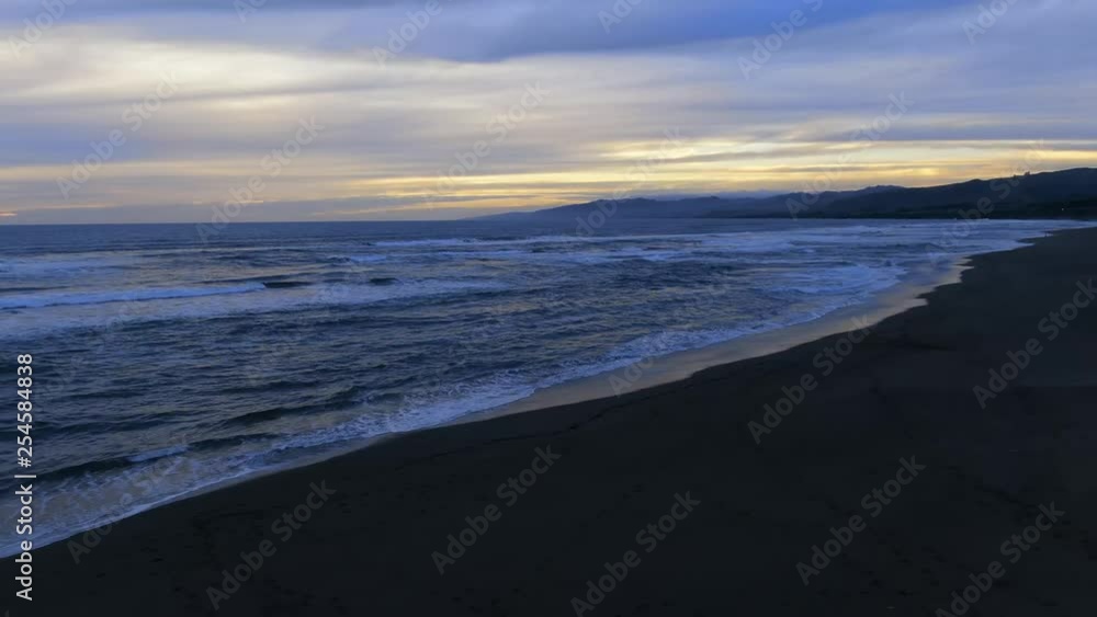 Sunset leaking through cloud cover at beach. Vibrant and beautiful Sunset leaking through cloud cover at beach. Vibrant and beautiful