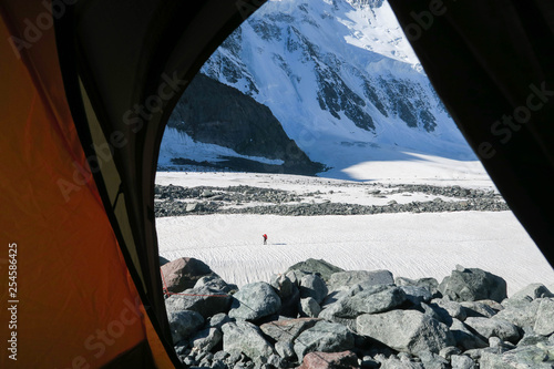 Mountain view from the tent. Mountain climber walking on the distance. Altai mountains